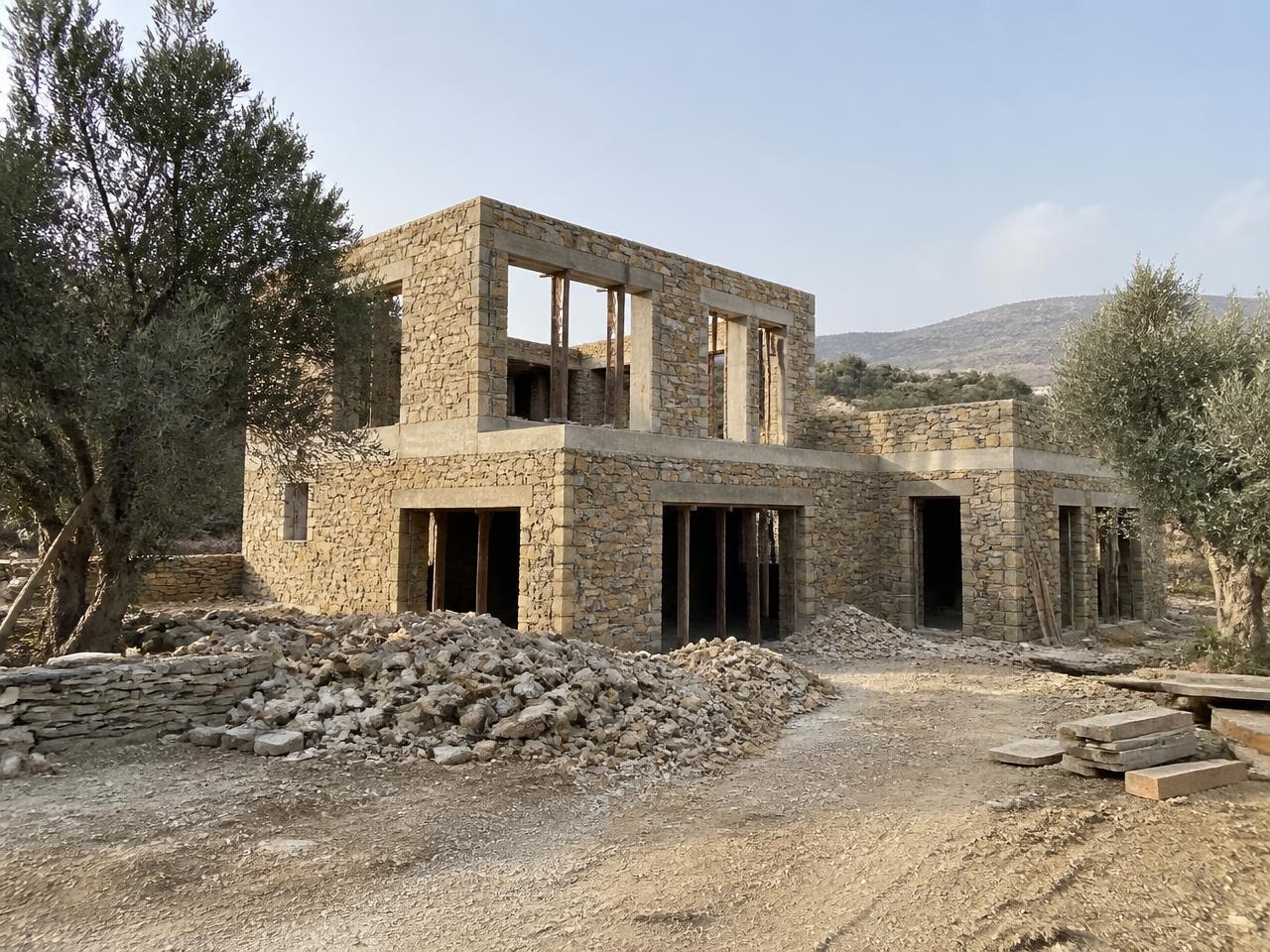 Villa C in Naxos under construction on the largest plot, stone shell with wide window openings