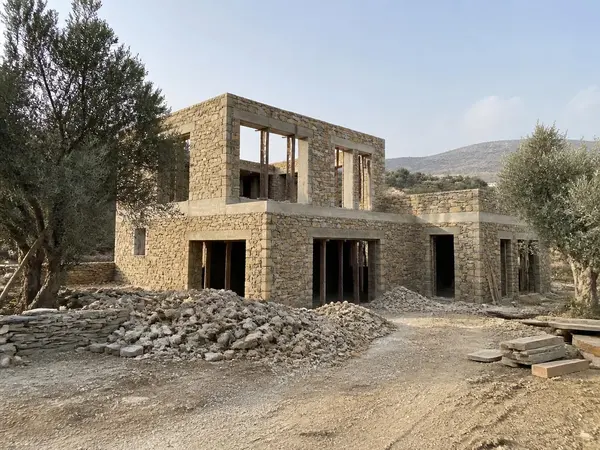 Villa C in Naxos under construction on the largest plot, stone shell with wide window openings